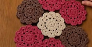 Crochet flower motifs in dusty rose, brown and cream joined into a table runner